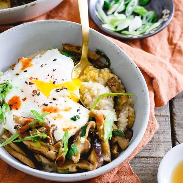 This savory Asian oat bran is simmered with spices and topped with sauteed shiitake mushrooms, fried eggs and garnished with sriracha. It's the perfect savory breakfast twist to traditional oat bran. Plus, not only does it make a great breakfast but it's also great for lunch or dinner! 