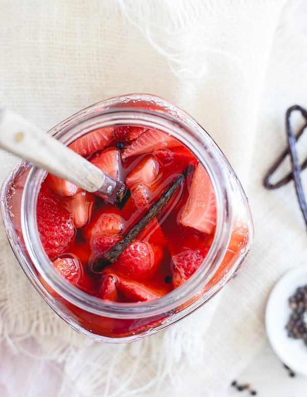 Pickled strawberries in a glass jar. 