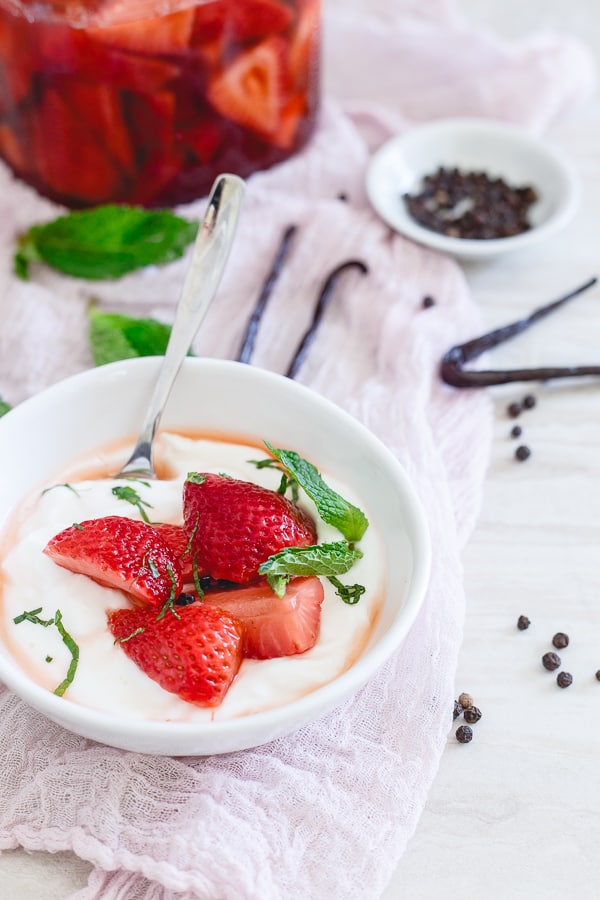 Pickled strawberries served over yogurt with fresh mint. 