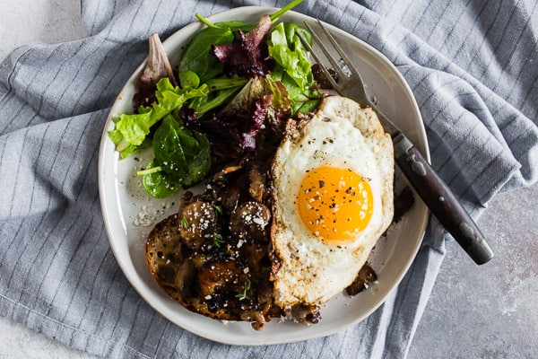 Garlic Wild Mushrooms on Toast on a white plate.