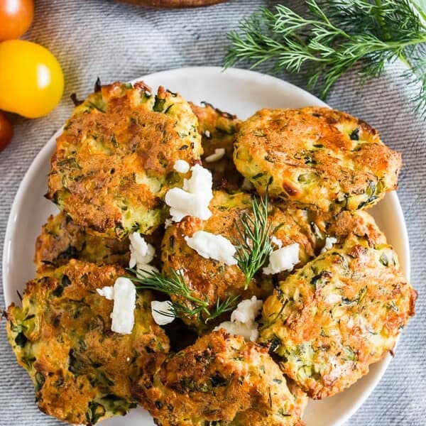These Greek zucchini fritters are the perfect appetizer and vegetable filled dipper. Made with shredded zucchini, feta cheese and lots of fresh herbs. You'll love how easy they are to make and how easy they are to devour! 