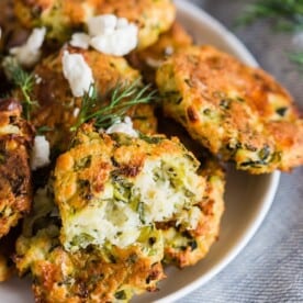 These Greek zucchini fritters are the perfect appetizer and vegetable filled dipper. Made with shredded zucchini, feta cheese and lots of fresh herbs. You'll love how easy they are to make and how easy they are to devour!