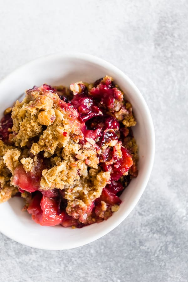 Cardamom Vanilla Plum Crisp spooned into a bowl. 