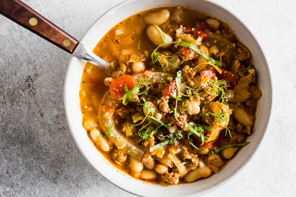 Italian Sausage Fennel White Bean Soup topped with parmesan cheese.