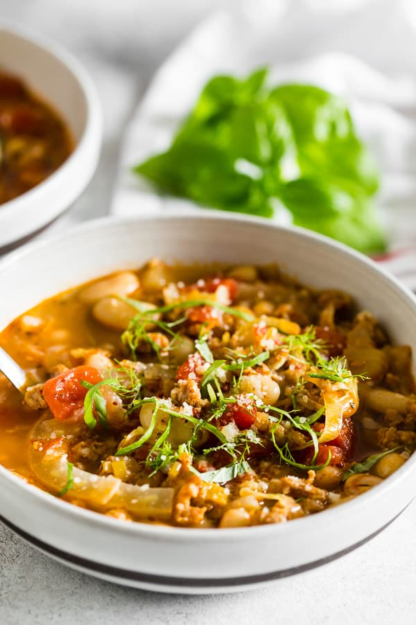 Italian Sausage Fennel White Bean Soup served with basil.