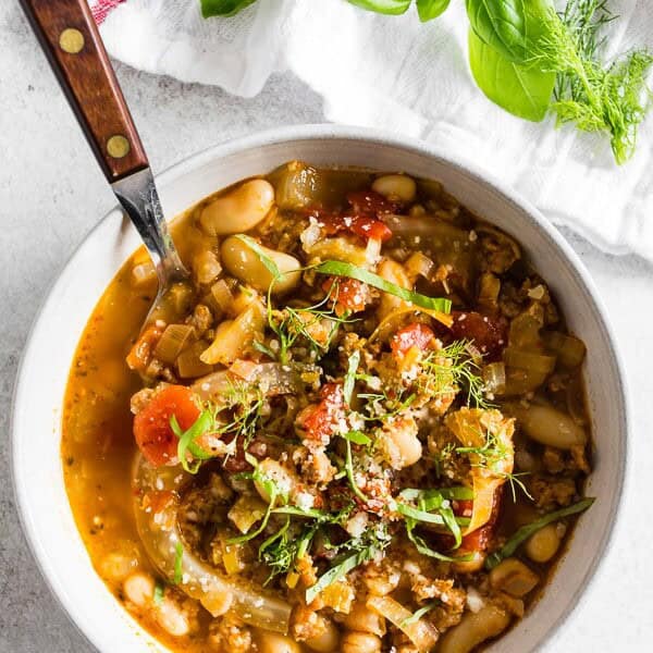 This Italian sausage fennel white bean soup is the perfect cool night soup. Packed with hot Italian sausage, flavorful fennel, white beans and lots of fresh basil. Youโll love all the flavor you get packed in this easy to throw together soup.