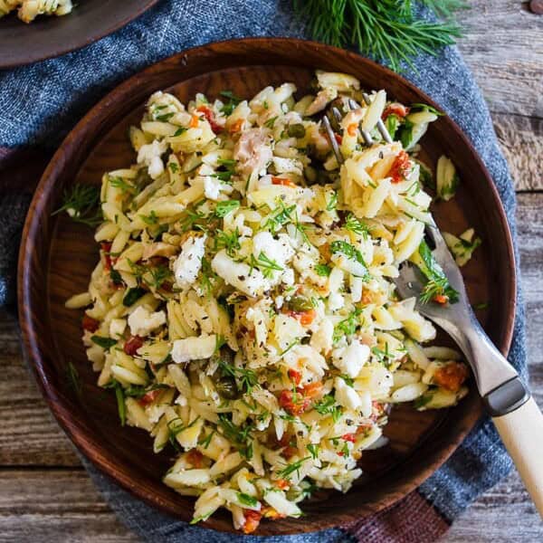 This Mediterranean tuna orzo salad is a great quick and easy weeknight meal. Protein packed tuna and orzo pasta mixed with lemon, capers, artichoke hearts, sundried tomatoes and lots of fresh herbs. You'll love this easy summertime meal!ย