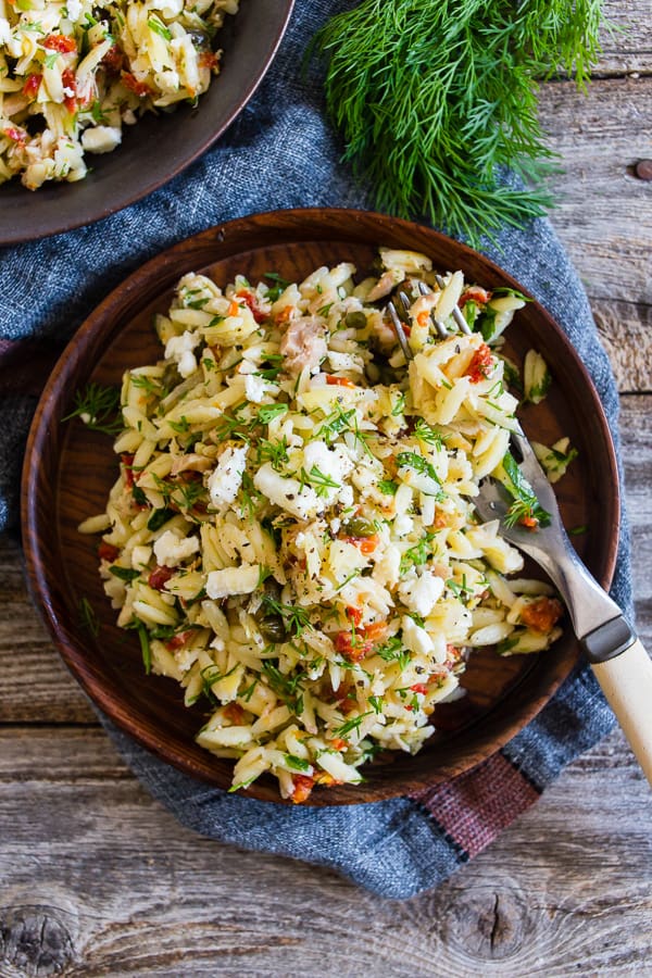 Mediterranean Tuna Orzo Salad on a small wooden plate.