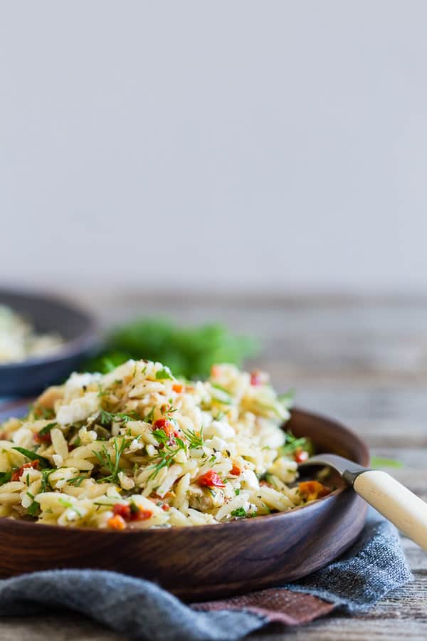 Mediterranean Tuna Orzo Salad sprinkled with fresh dill.