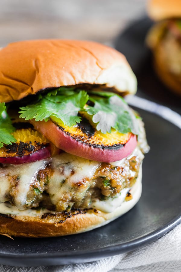Cheesy Grilled Peach Jalapeno Turkey Burger on a plate. 