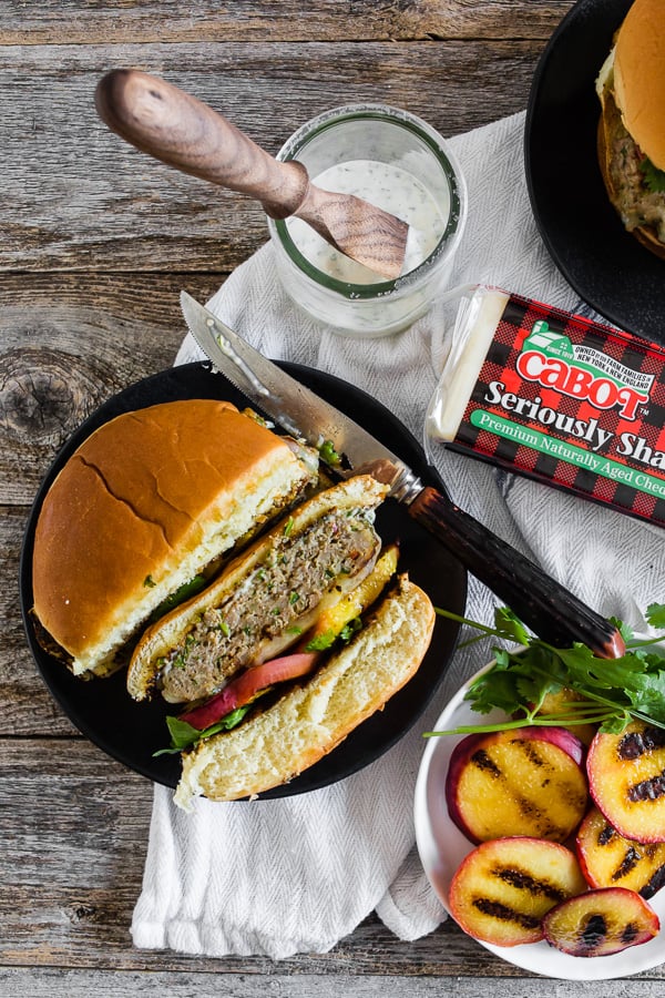 Cheesy Grilled Peach Jalapeno Turkey Burger served with extra peaches. 
