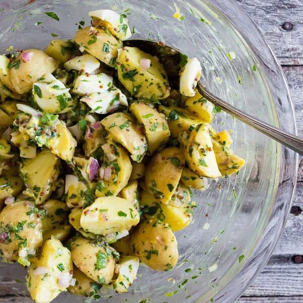 This honey mustard potato salad can be served warm or cold but the best part is that it's mayonnaise free, packed full of herbs and just the right amount of whole grain mustard and natural honey. It's a fun twist to traditional potato salad and you'll love the sweet and savory combination.