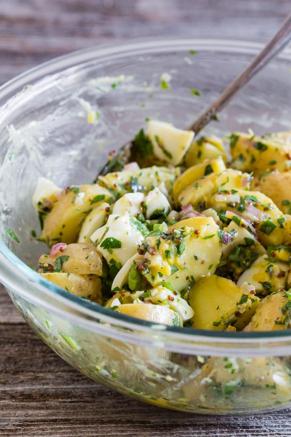 Honey Mustard Potato Salad topped with herbs. 