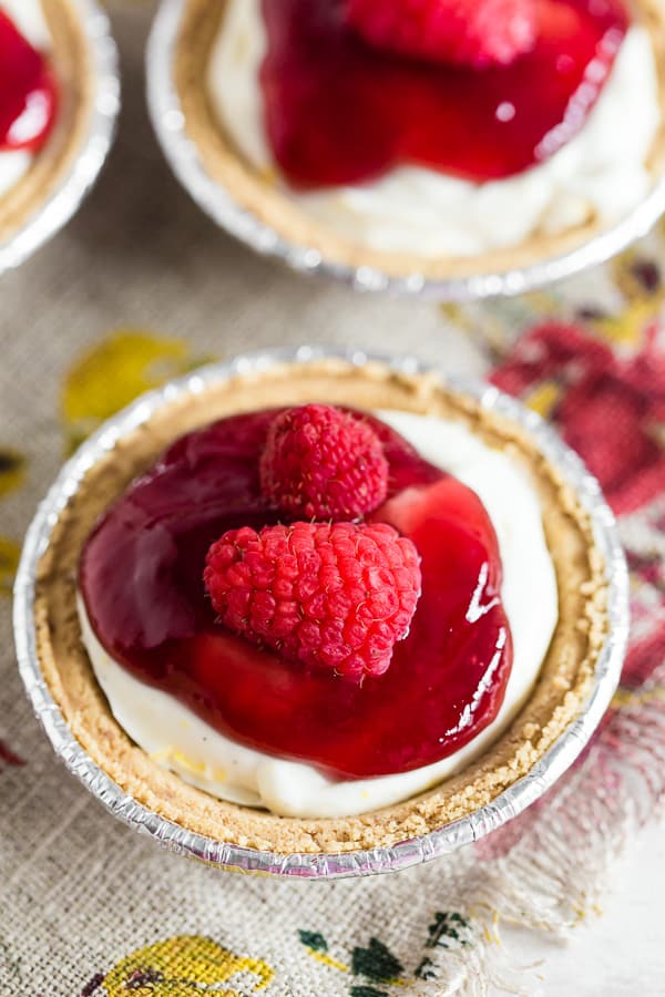These no bake raspberry lemon mini cheesecakes are going to be your new favorite summer dessert. Lots of big time lemon flavor packed into a creamy cheesecake mixture and topped with raspberry jam and fresh raspberries. It's the perfect mixture of sweet and tart!