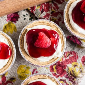 These no bake raspberry lemon mini cheesecakes are going to be your new favorite summer dessert. Lots of big time lemon flavor packed into a creamy cheesecake mixture and topped with raspberry jam and fresh raspberries. It's the perfect mixture of sweet and tart!