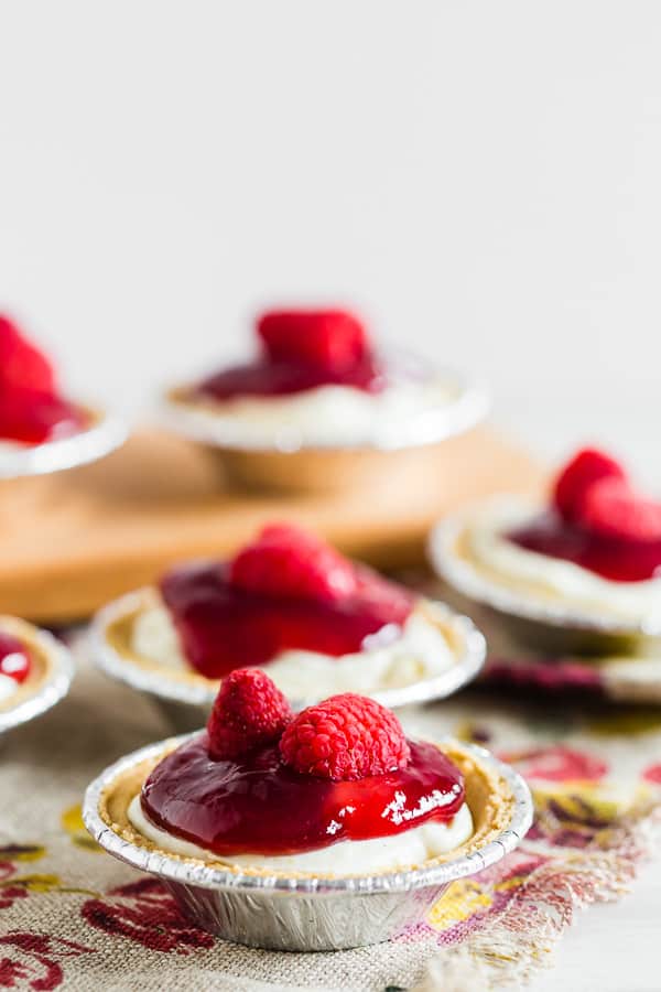 These no bake raspberry lemon mini cheesecakes are going to be your new favorite summer dessert. Lots of big time lemon flavor packed into a creamy cheesecake mixture and topped with raspberry jam and fresh raspberries. It's the perfect mixture of sweet and tart!