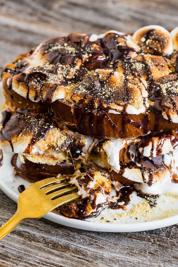a fork taking a bite out of s'mores french toast.