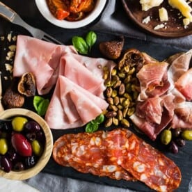 This Italian salumi board is the perfect combination of delicious imported Italian meats, imported Italian cheese, nuts, dried fruit, olives, roasted tomatoes, pickled vegetables and grilled bread. It makes a great appetizer or a simple summer meal - no cooking required!