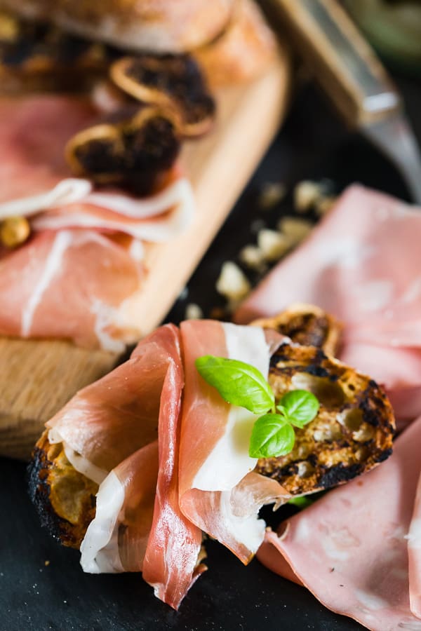 Close-up of thin-sliced meat on a toasted crust of bread.