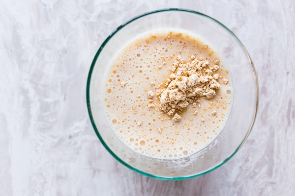 Overhead view of peanut butter protein shake in a glass.