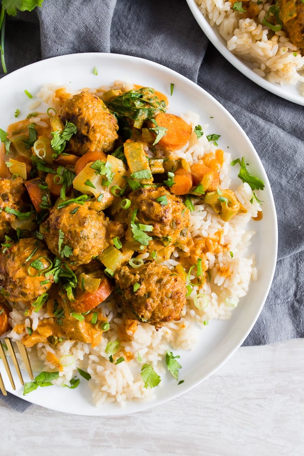 Red Curry Turkey Meatballs on a white plate with rice. 