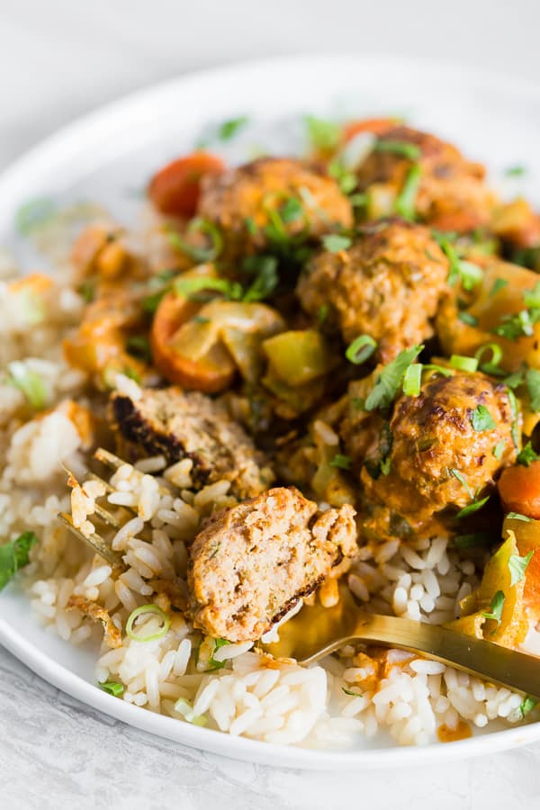 Red Curry Turkey Meatball cut in half on a fork. 