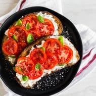 This ricotta tomato toast is my favorite way to start the day. Crunchy toasted whole wheat sourdough spread with creamy ricotta cheese and topped with sun-ripened tomatoes, kosher salt, and black pepper. For an extra boost of flavor add some fresh basil leaves. 