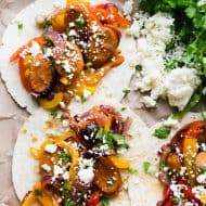These sheet pan chicken sausage fajitas are a great weeknight meal that can feed a hungry crowd. Sweet peppers, red onions, and juicy chicken sausage all tossed together with a homemade fajita seasoning and topped with fresh chopped cilantro and crumbly cotija cheese.