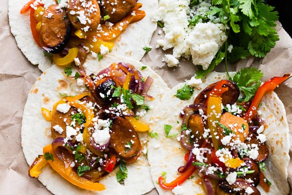 Sheet Pan Chicken Sausage Fajitas topped with cheese. 
