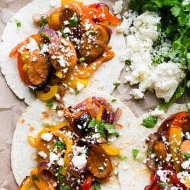 These sheet pan chicken sausage fajitas are a great weeknight meal that can feed a hungry crowd. Sweet peppers, red onions, and juicy chicken sausage all tossed together with a homemade fajita seasoning and topped with fresh chopped cilantro and crumbly cotija cheese.