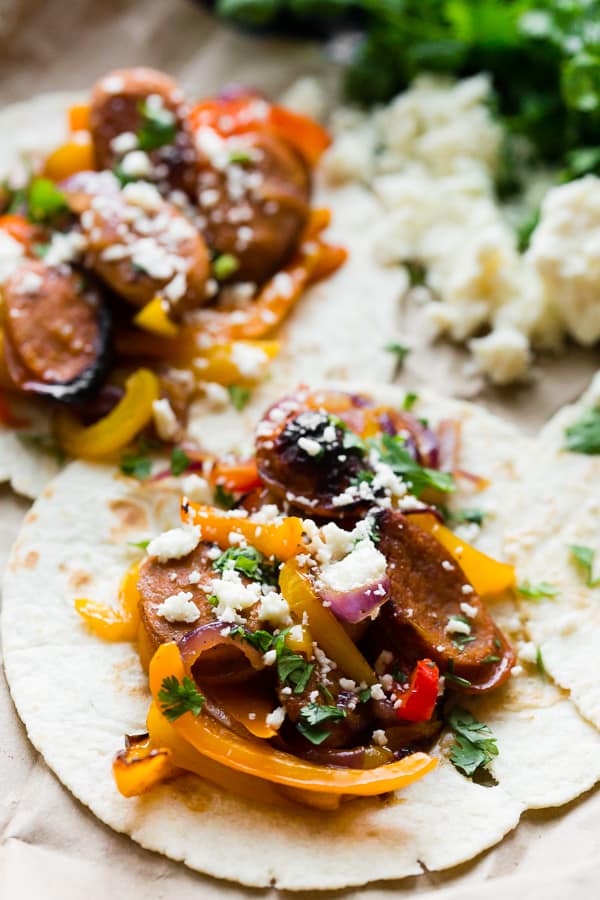 Sheet Pan Chicken Sausage Fajitas on a flour tortilla. 