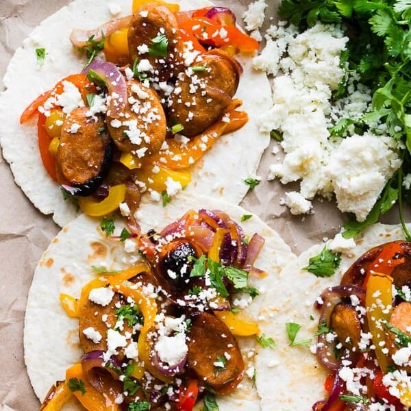 These sheet pan chicken sausage fajitas are a great weeknight meal that can feed a hungry crowd. Sweet peppers, red onions, and juicy chicken sausage all tossed together with a homemade fajita seasoning and topped with fresh chopped cilantro and crumbly cotija cheese.