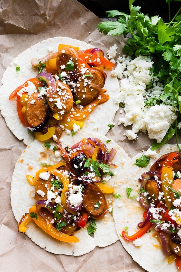 Sheet Pan Chicken Sausage Fajitas topped with cheese and cilantro. 