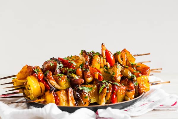 Pineapple Chicken Kebabs on a black ceramic plate. 