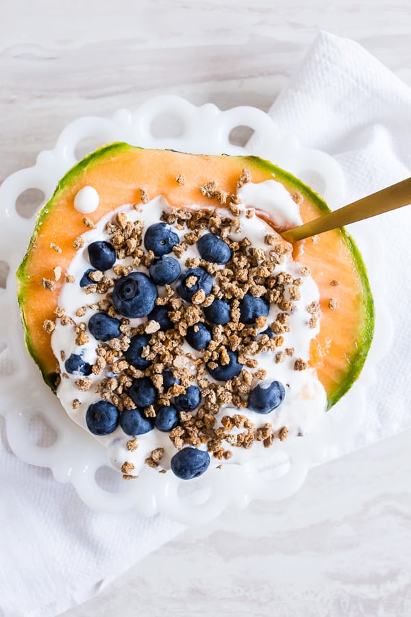 Crunchy Yogurt Cantaloupe Breakfast Bowl on a plate. 