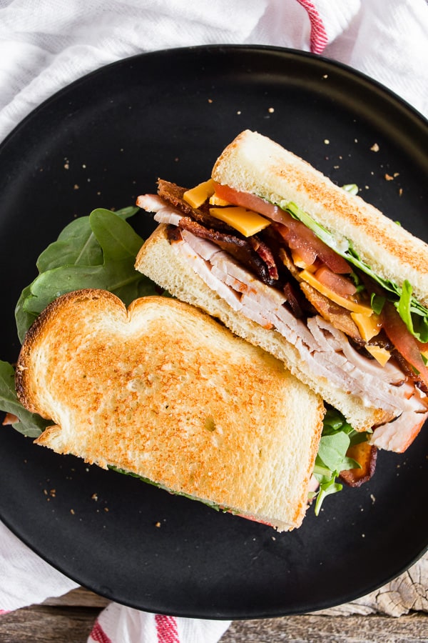Close-up of turkey BLT sandwich cut in half.