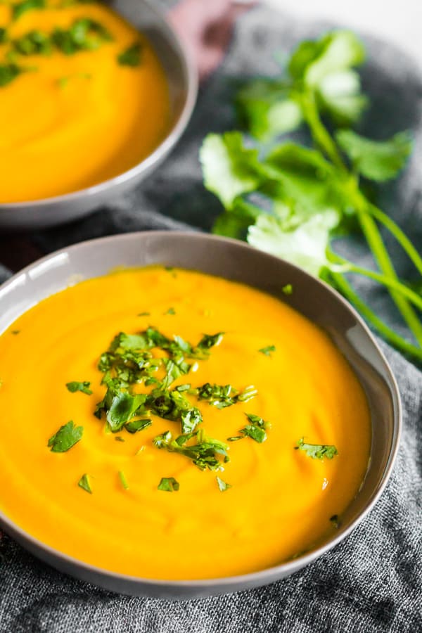 Creamy Carrot Orange Soup in a grey bowl. 
