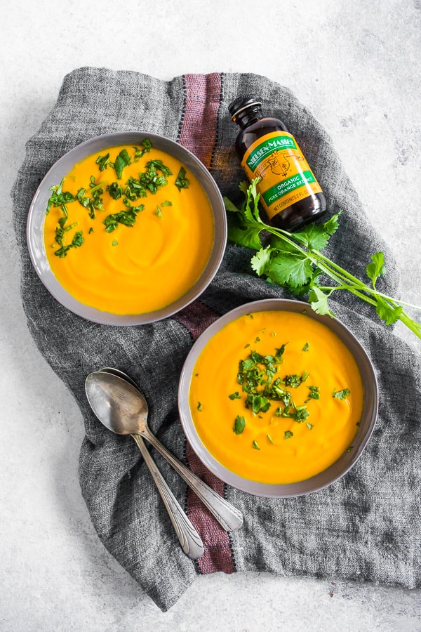 Creamy Carrot Orange Soup topped with minced cilantro. 