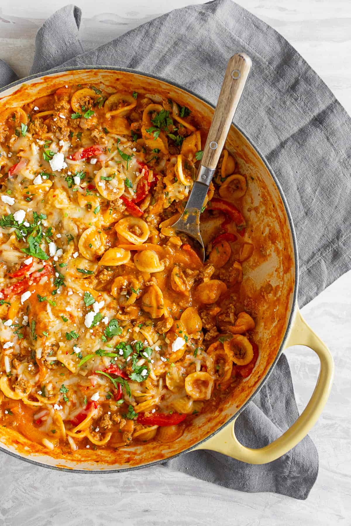 one pot ground chicken fajita pasta in a skillet with a spoon