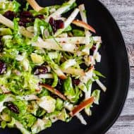 This tangy Brussels sprout apple slaw is a great addition to your fall menu. Crispy shaved Brussels sprout combined with dried cranberries, and apples all tossed in a homemade shallot whole grain mustard vinaigrette. You'll love this simple side dish!