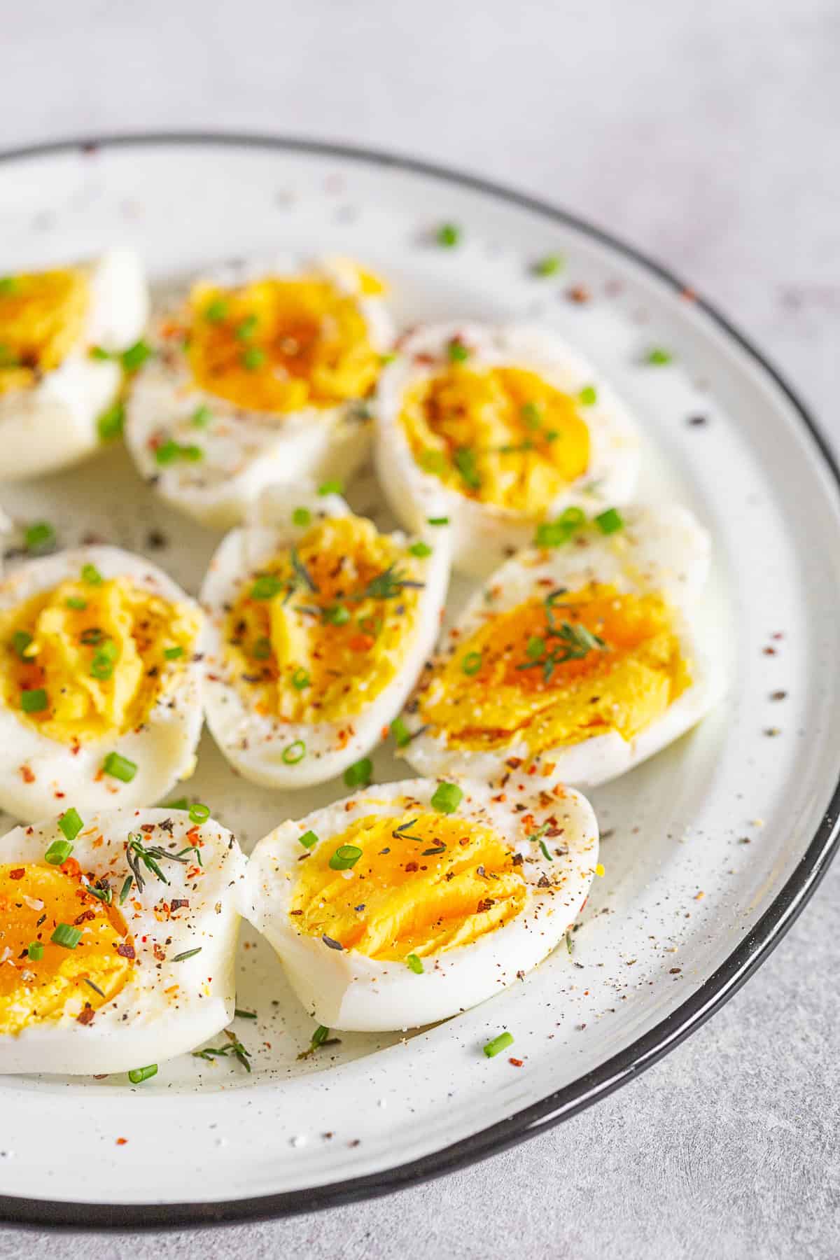 Instant Pot Hard Boiled Eggs topped with fresh herbs and spices. 