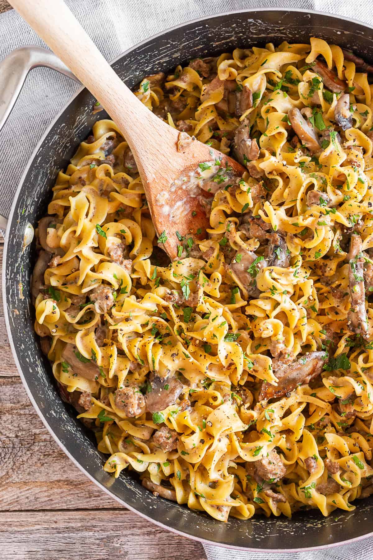 One Pot Beef Stroganoff in a pot with a wooden spoon. 