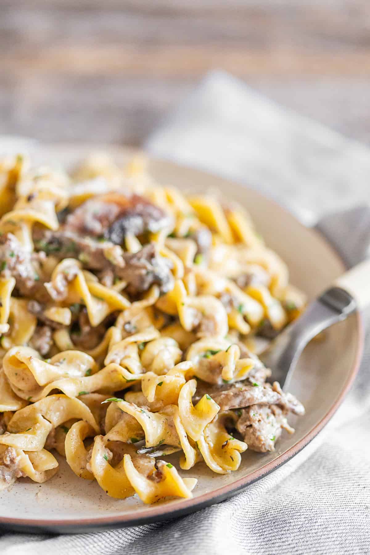One Pot Beef Stroganoff on a tan plate. 