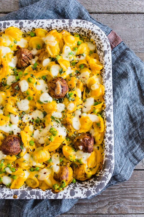Alfredo Meatball Pasta Bake sprinkled with cheese.