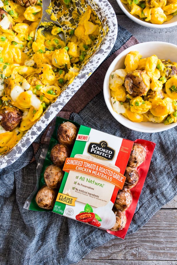 Pumpkin Cauliflower Alfredo Meatball Pasta Bake on a table with more chicken meatballs.