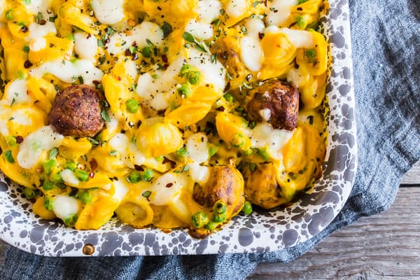 Pumpkin Cauliflower Alfredo Meatball Pasta Bake topped with fresh herbs.