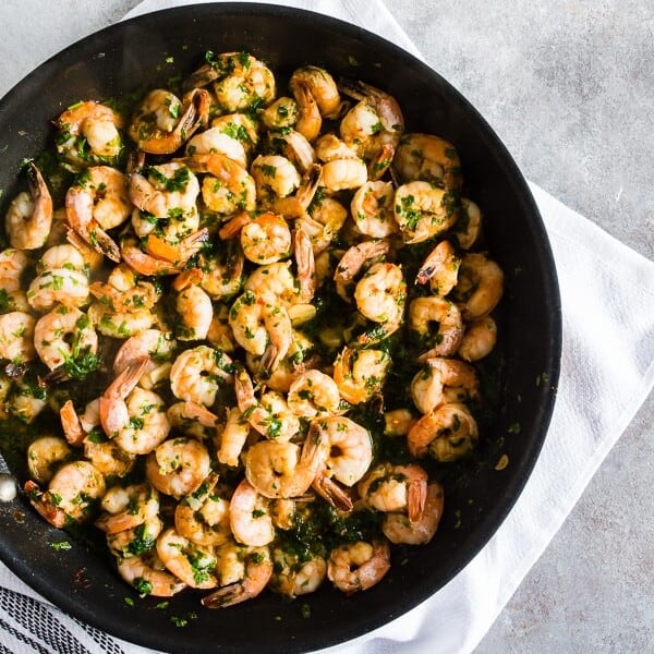 This spicy garlic cilantro shrimp is the perfect easy dinner or party appetizer. Made with spicy cayenne olive oil, dry sherry, lots of thinly sliced garlic, garlic chili sauce, wild-caught shrimp and lots of fresh cilantro. You’ll love this quick and easy dish!