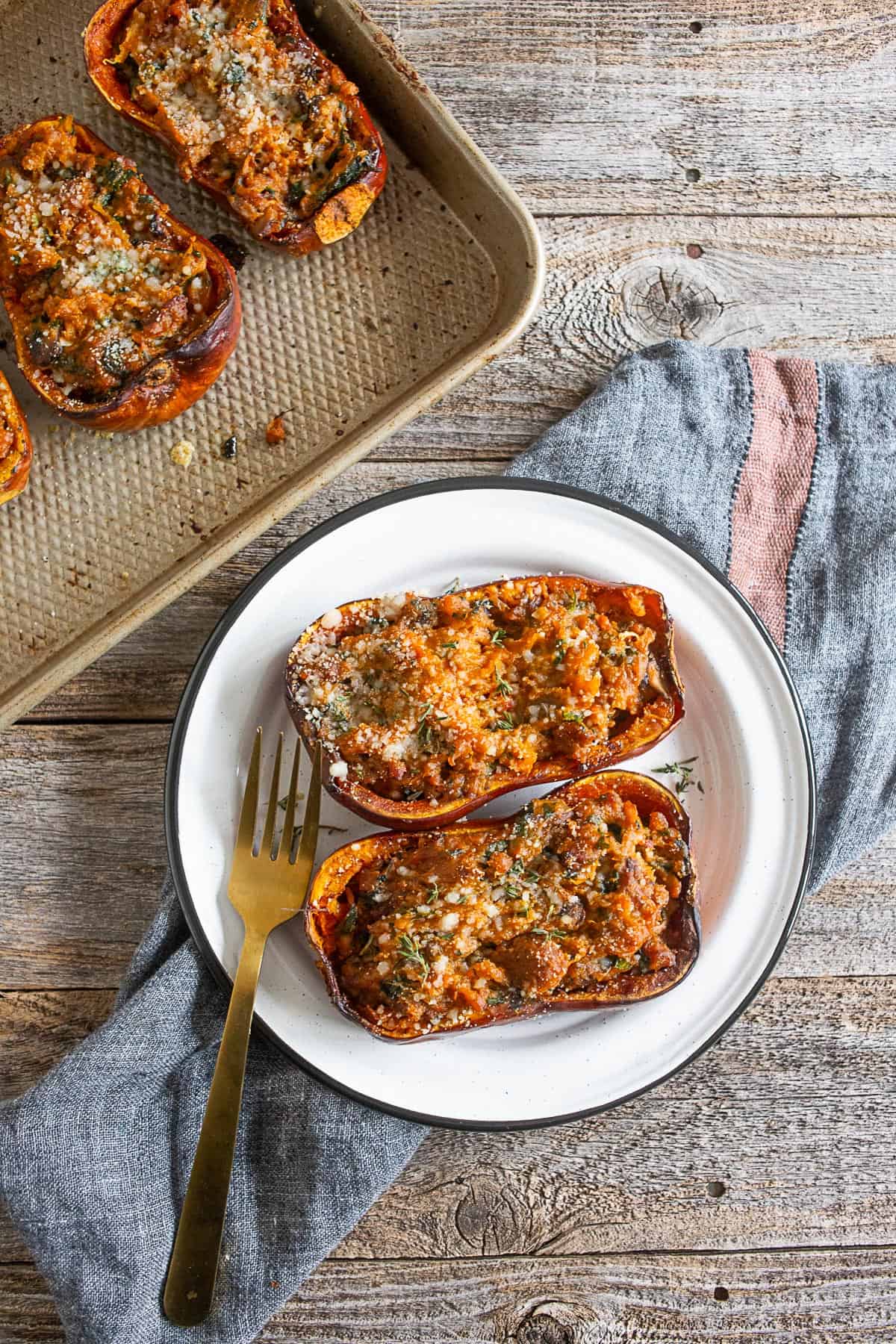 stuffed honeynut squash served on a white plate.