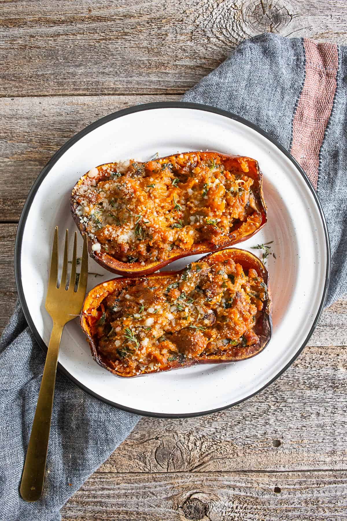 stuffed honeynut squash on a white plate.