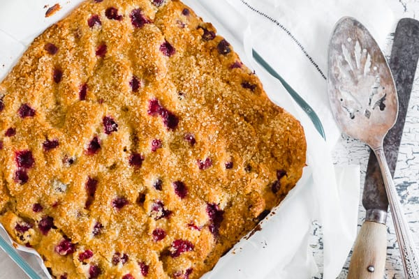 Vanilla Cranberry Buttermilk Cake sprinkled with sugar.